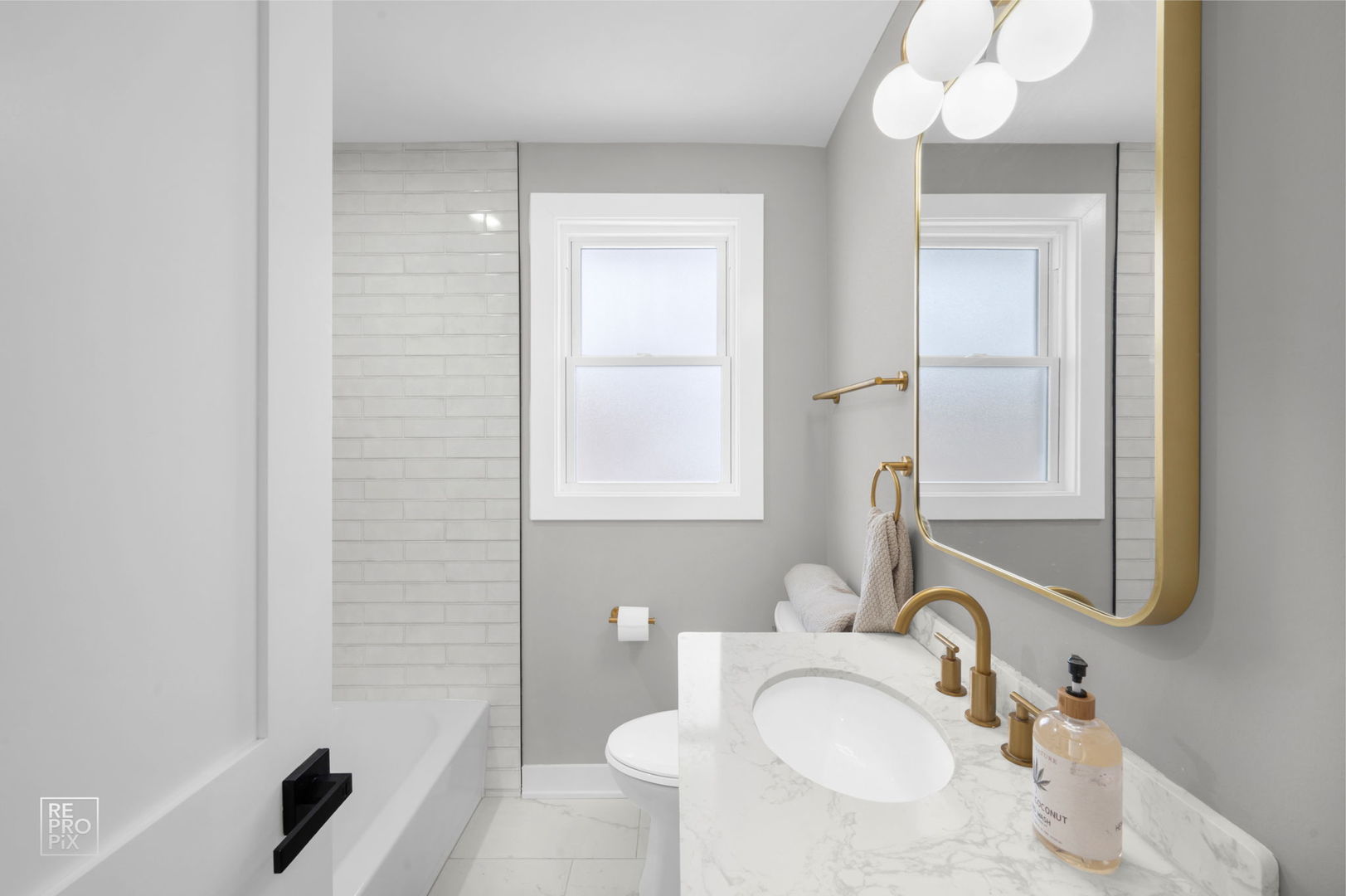 9133 Oak Park Avenue Morton Grove, IL 60053 - Photo 6 of 10 a bathroom with a sink vanity tub and a mirror