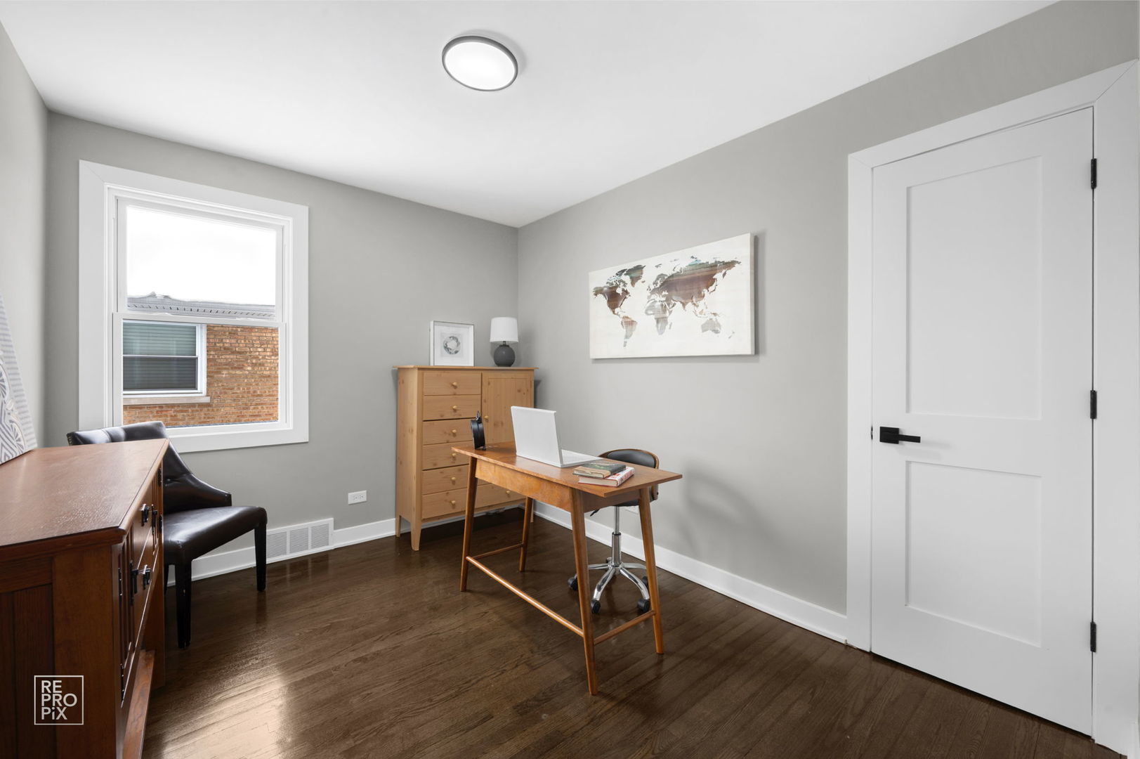 9133 Oak Park Avenue Morton Grove, IL 60053 - Photo 7 of 10 a view of a workspace with furniture and a window