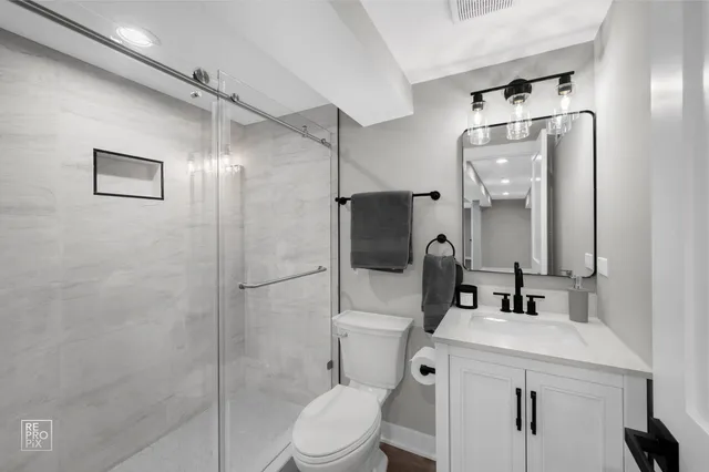 a bathroom with a toilet sink and shower