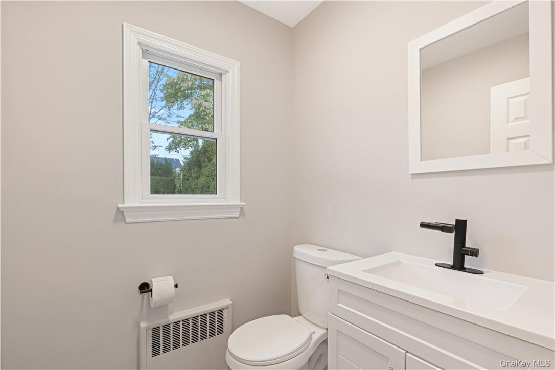 5 Paddock Road Rye Brook, NY 10573 - Photo 8 of 23 Bathroom featuring vanity with toilet and temperature controlled faucet