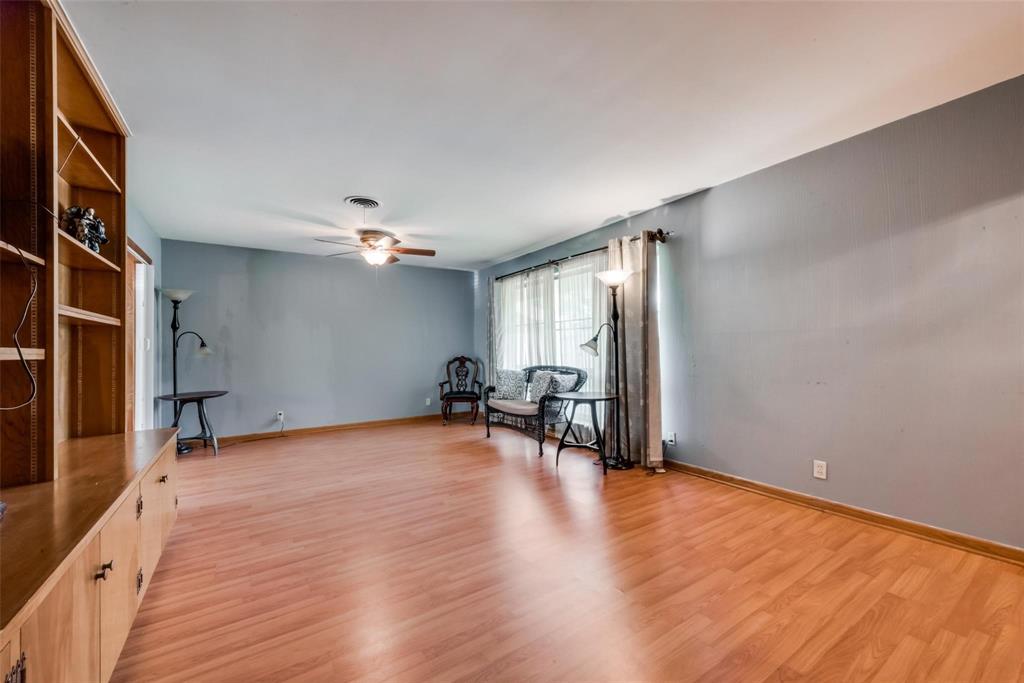 821 North Hampton Road Dallas, TX 75208 - Photo 2 of 11 a view of empty room with wooden floor and fan