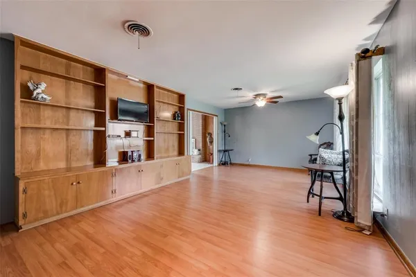 a view of a workspace with furniture and wooden floor