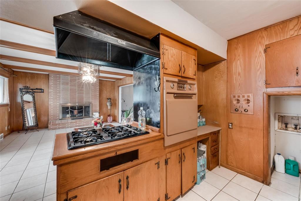 821 North Hampton Road Dallas, TX 75208 - Photo 5 of 11 a kitchen with stainless steel appliances kitchen island granite countertop a stove and a refrigerator