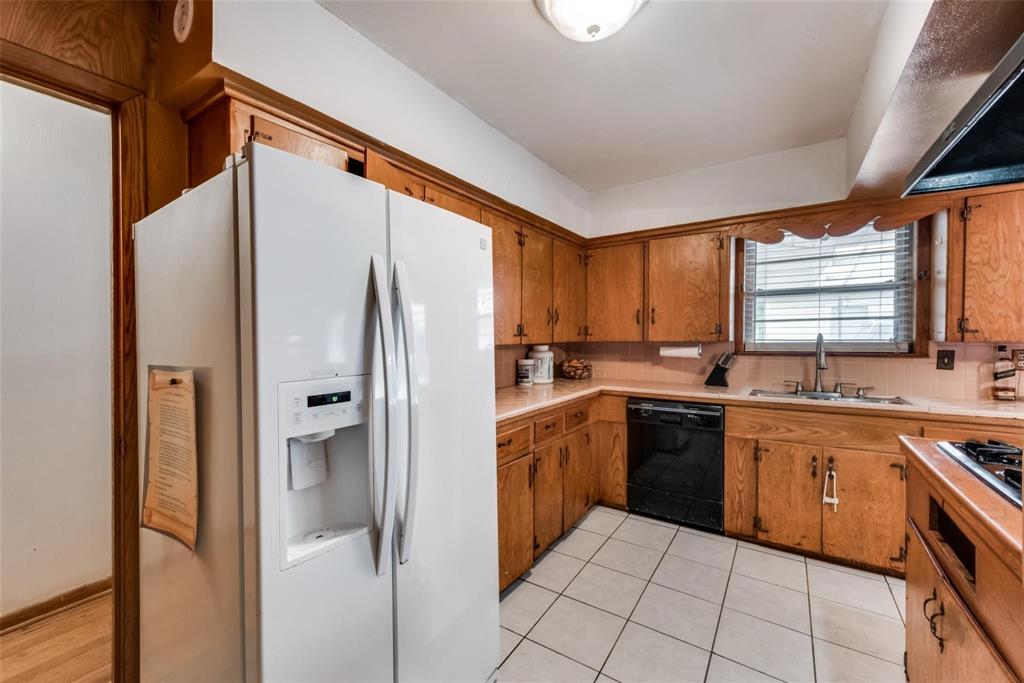 821 North Hampton Road Dallas, TX 75208 - Photo 6 of 11 a kitchen with stainless steel appliances granite countertop a refrigerator and a sink