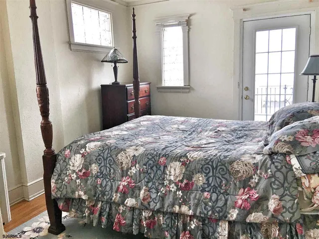 a bedroom with a bed window and flowerpot
