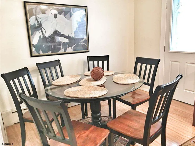 a view of a dining room with furniture and window