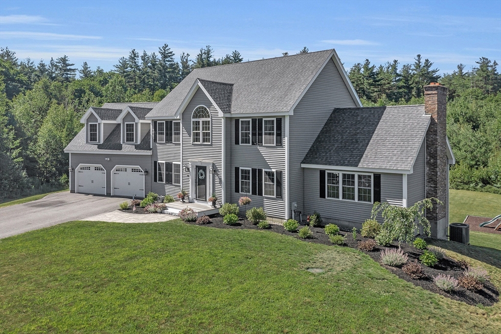 65 Easter Brook Road Lunenburg, MA 01462 - Photo 1 of 39 a aerial view of a house with garden and trees