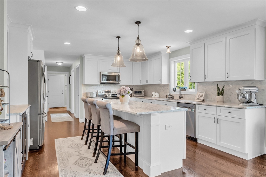 65 Easter Brook Road Lunenburg, MA 01462 - Photo 12 of 39 a kitchen with kitchen island granite countertop a sink cabinets and wooden floor