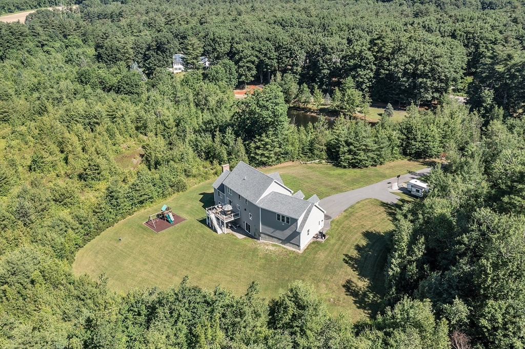65 Easter Brook Road Lunenburg, MA 01462 - Photo 38 of 39 an aerial view of a house with pool and trees all around