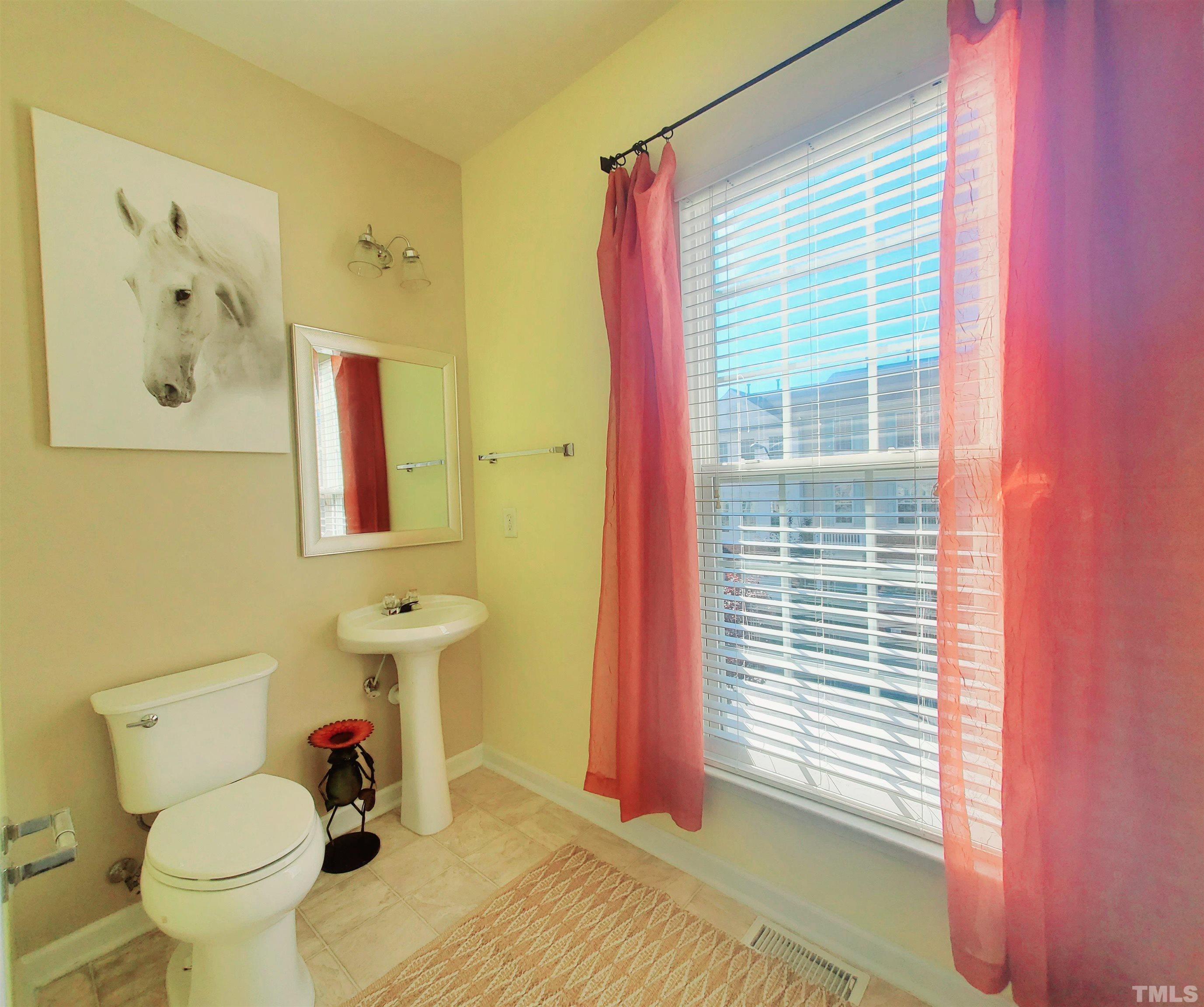 7236 Galon Glen Road Raleigh, NC 27613 - Photo 14 of 24 a bathroom with a toilet sink and mirror