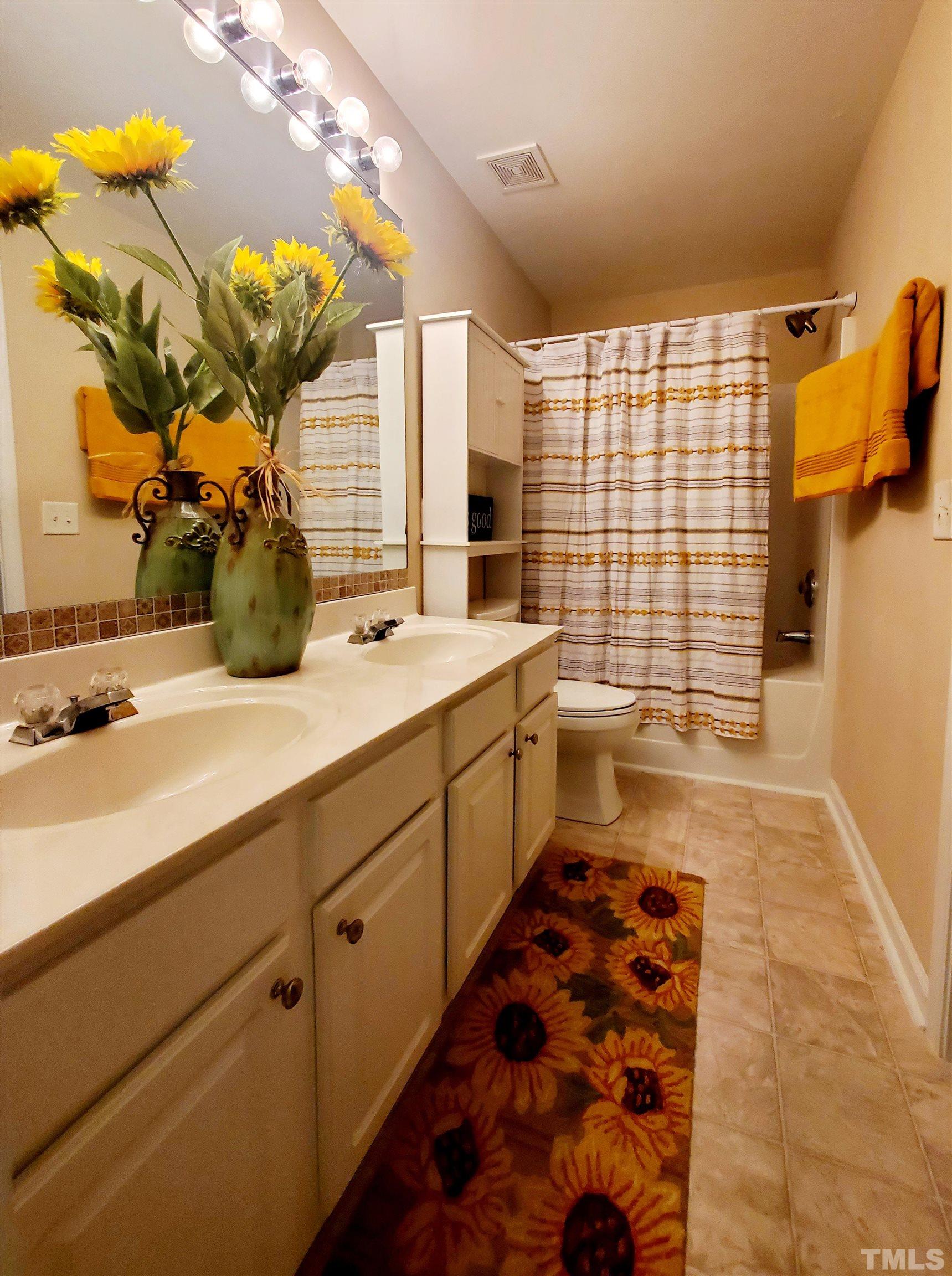7236 Galon Glen Road Raleigh, NC 27613 - Photo 17 of 24 a bathroom with a sink a toilet and shower