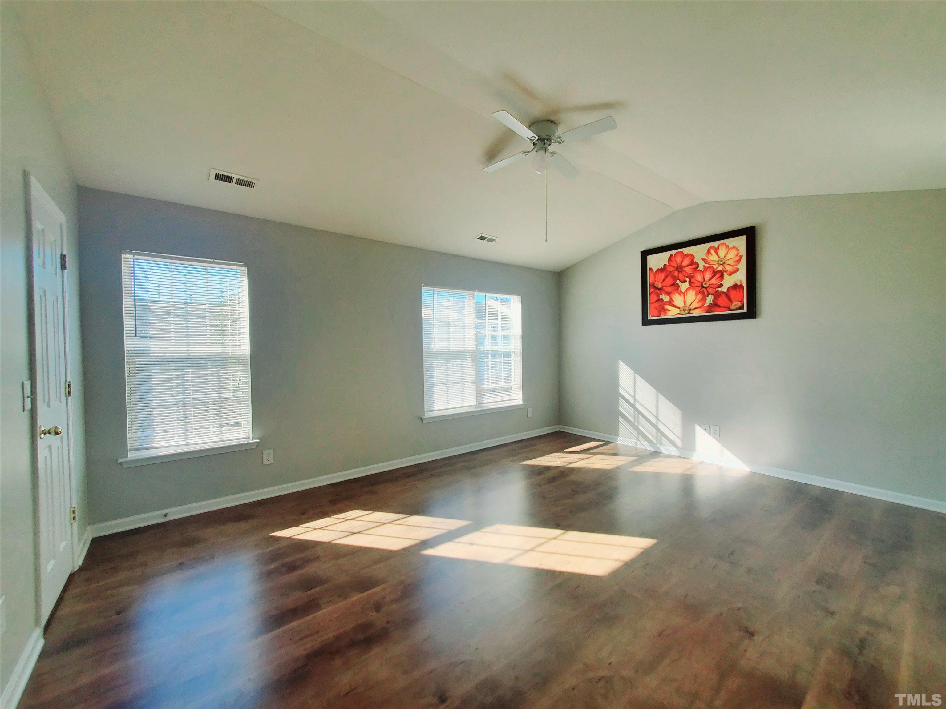 7236 Galon Glen Road Raleigh, NC 27613 - Photo 19 of 24 a view of empty room with wooden floor and fan