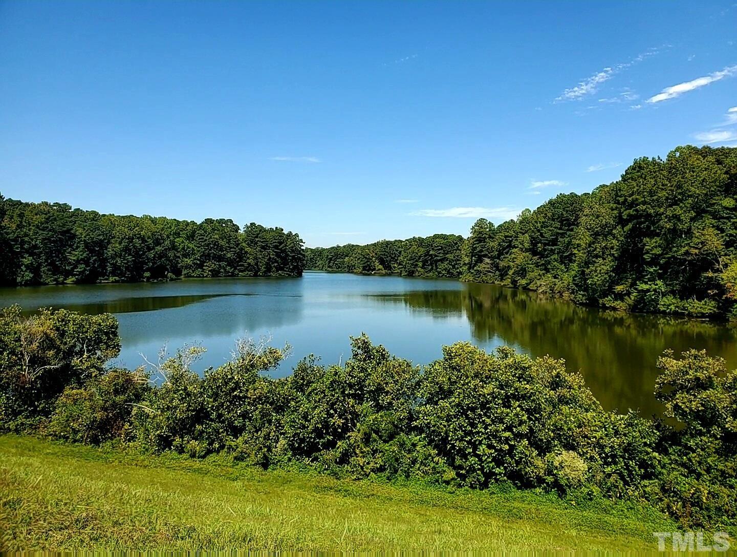 7236 Galon Glen Road Raleigh, NC 27613 - Photo 24 of 24 a view of a lake with a house in the background