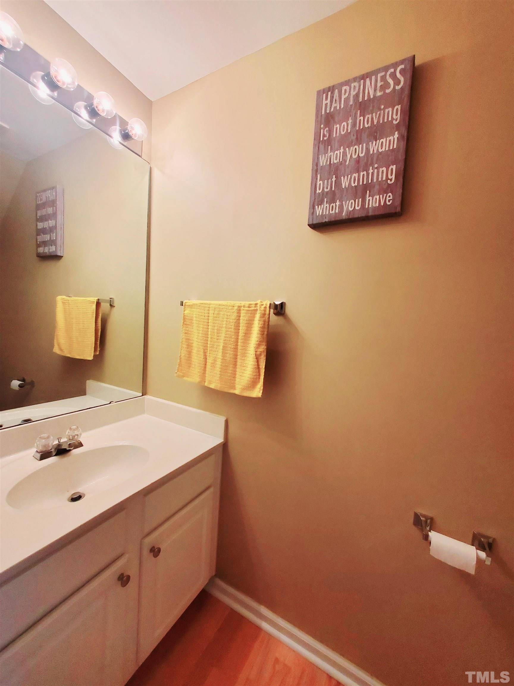 7236 Galon Glen Road Raleigh, NC 27613 - Photo 7 of 24 a bathroom with a sink and a mirror