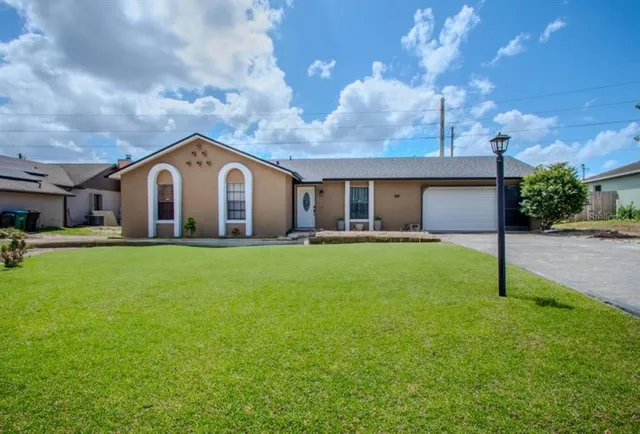 a front view of house with yard and green space