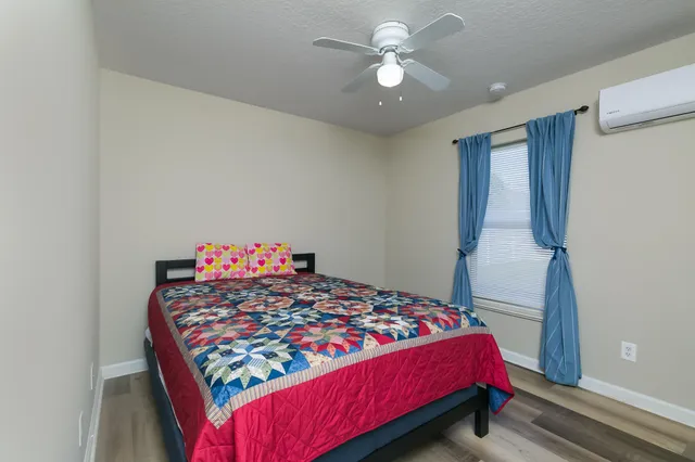 a bed sitting in a bedroom next to a window