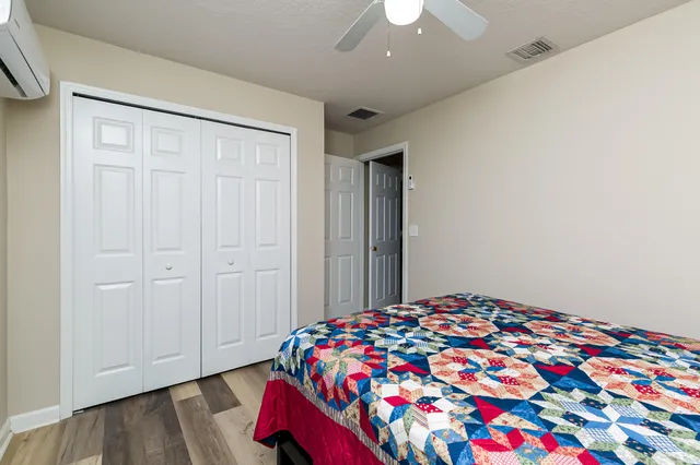 a bedroom with a bed and a chandelier