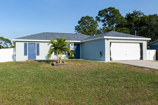 a view of a house with a yard and a garden