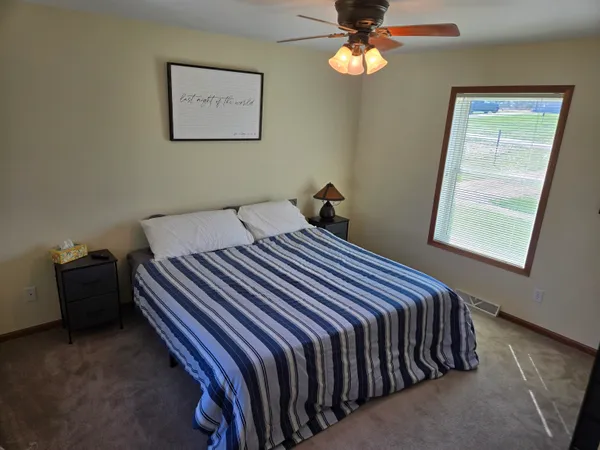 a bedroom with bed and a window