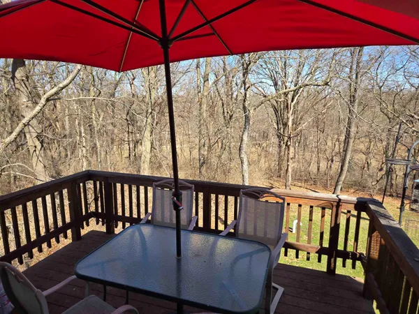 a view of a balcony with furniture and umbrella
