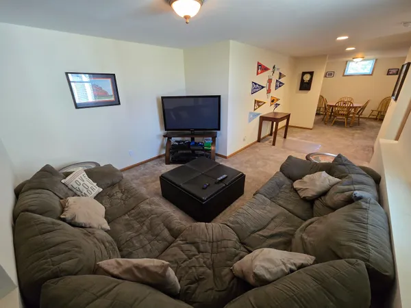 a living room with furniture a couch and a flat screen tv