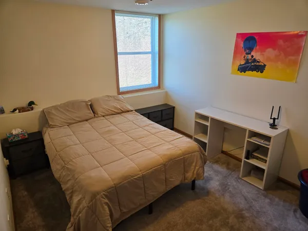 a bedroom with a bed and a desk