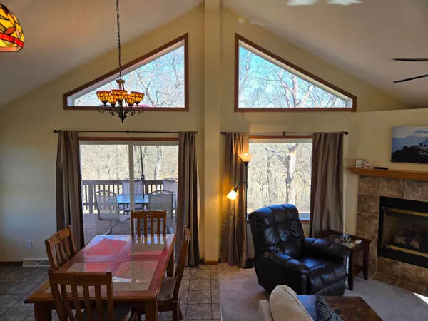 a living room with furniture a fireplace and a large window