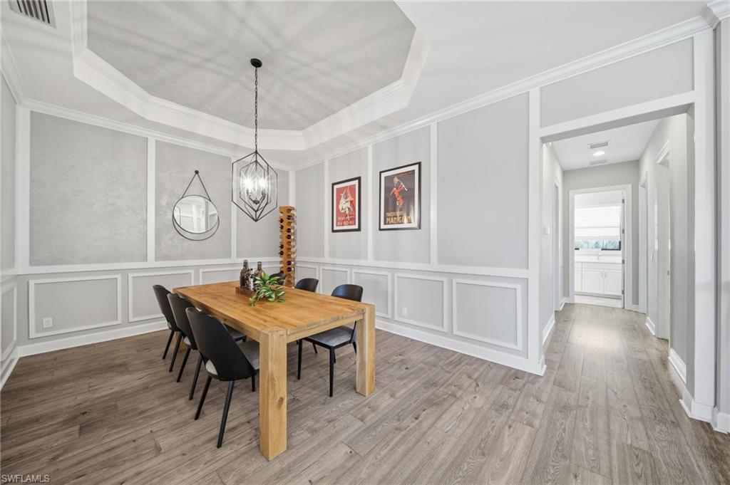 9658 Montelanico Loop, Unit 201 Naples, FL 34119 - Photo 14 of 46 a view of a dining room with furniture window and wooden floor