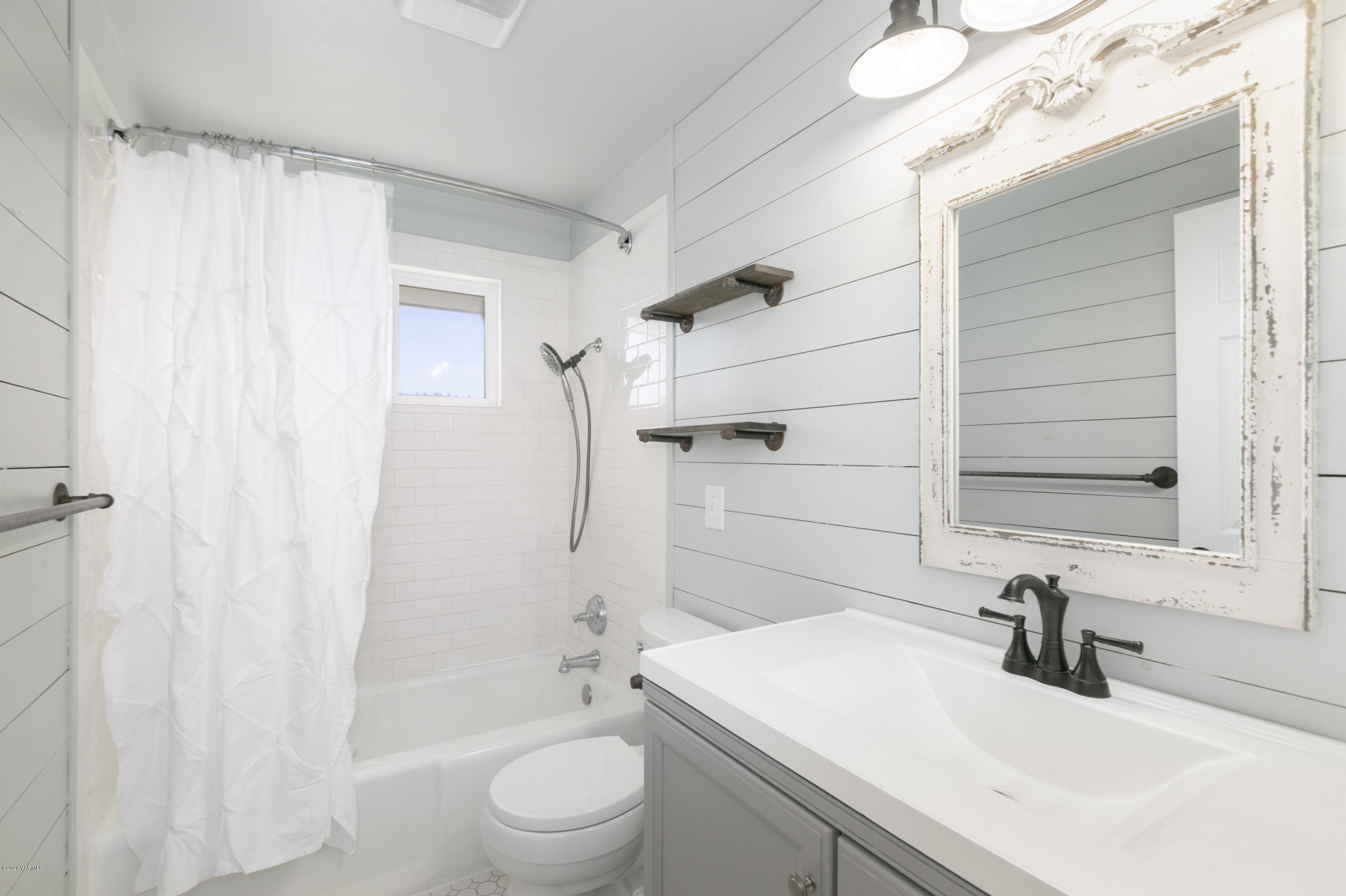 12306 Summitview Ext Road Yakima, WA 98908 - Photo 15 of 30 a bathroom with a sink a toilet a mirror and shower
