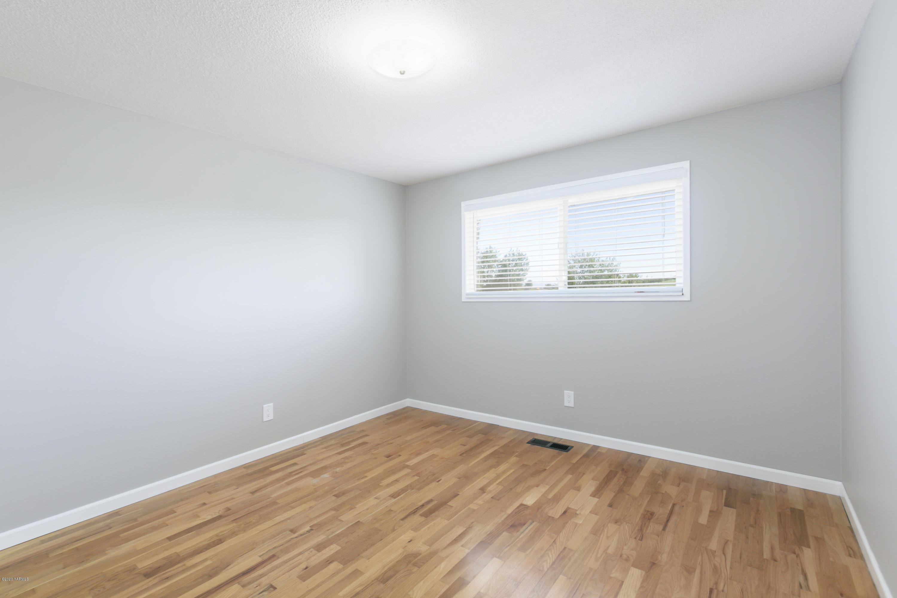 12306 Summitview Ext Road Yakima, WA 98908 - Photo 16 of 30 a view of an empty room with wooden floor and a window
