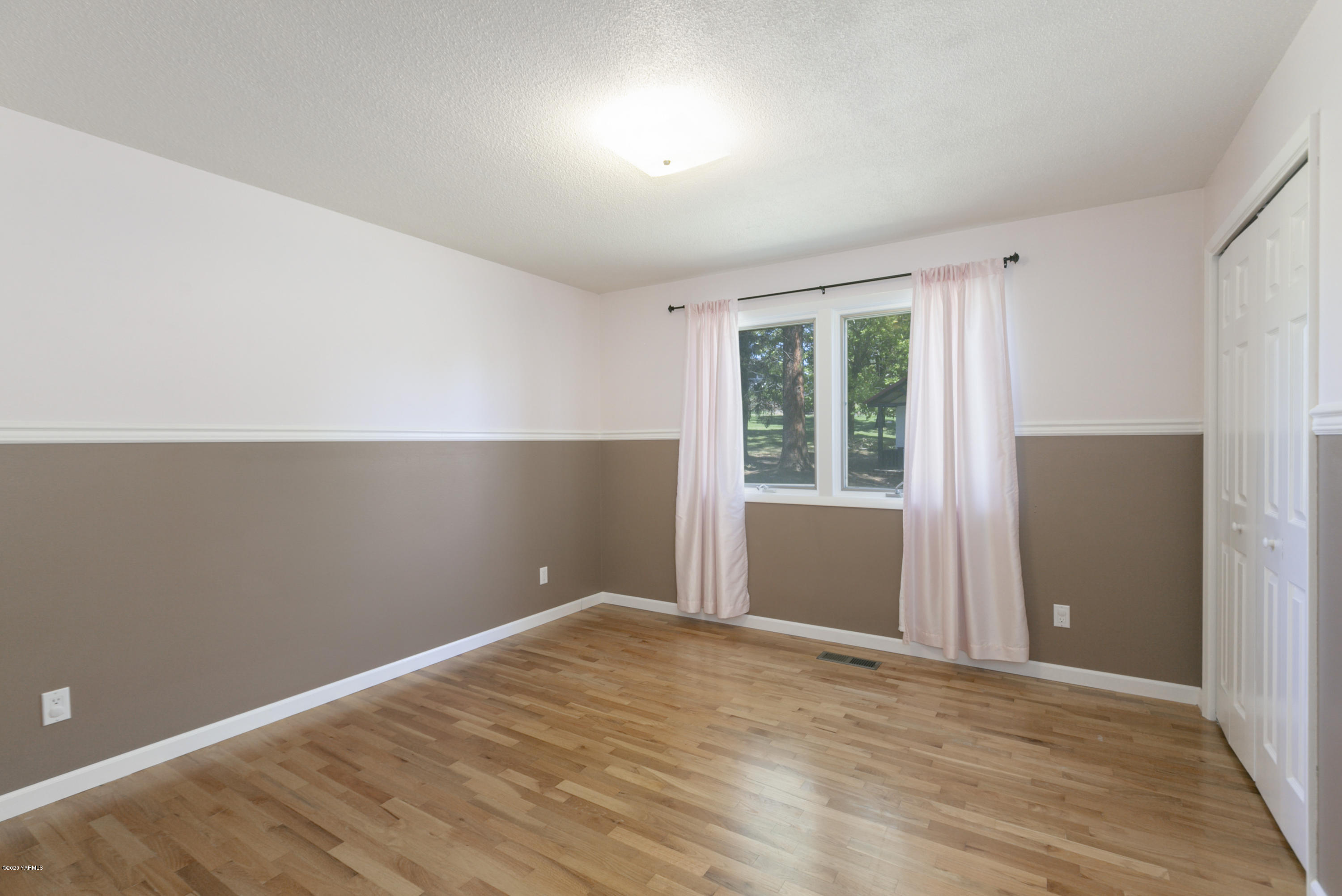 12306 Summitview Ext Road Yakima, WA 98908 - Photo 17 of 30 an empty room with wooden floor and windows