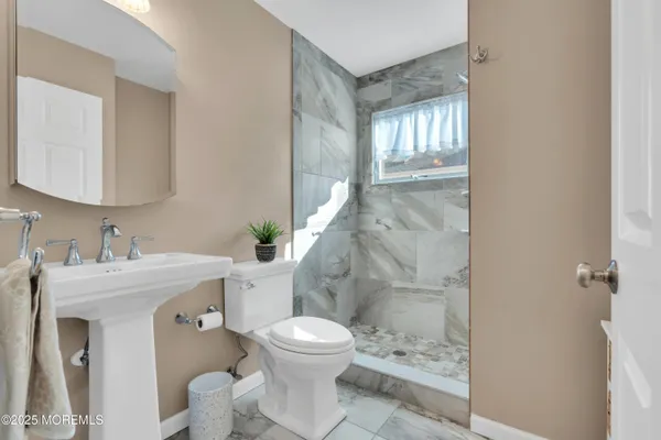 a bathroom with a sink toilet and shower