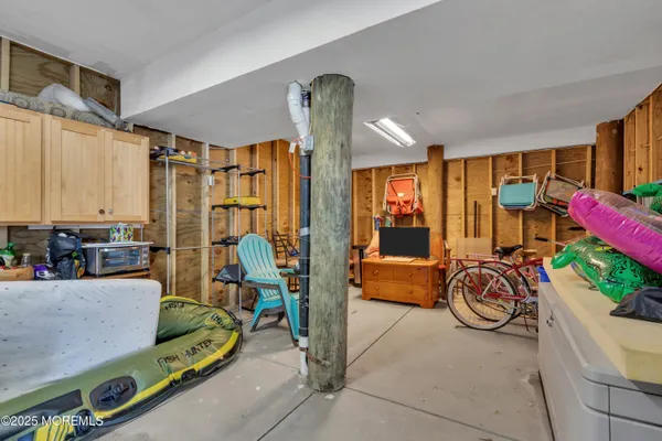 a bedroom with furniture and large windows