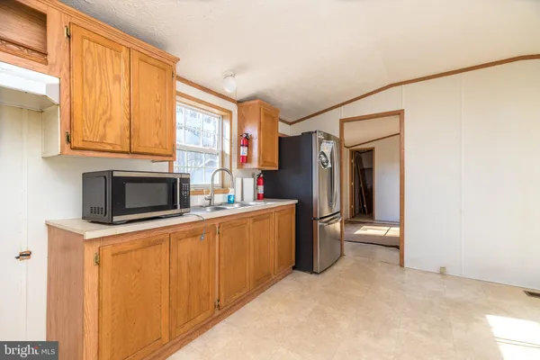 a view of a kitchen with a sink and cabinet