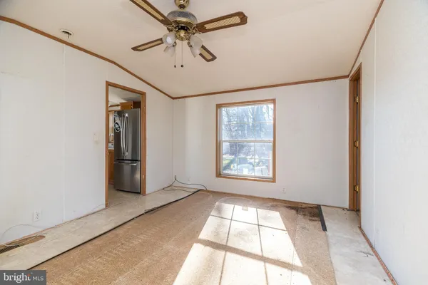 a view of a room with a ceiling fan