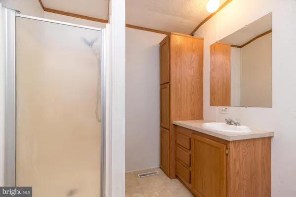 a white toilet sitting next to a bathroom sink