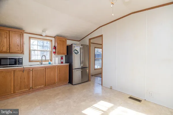 a kitchen with refrigerator cabinets and a window