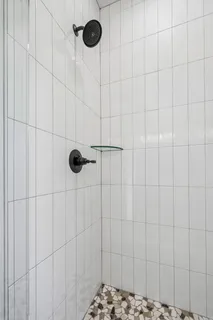 a bathroom with a bathtub toilet and a shower