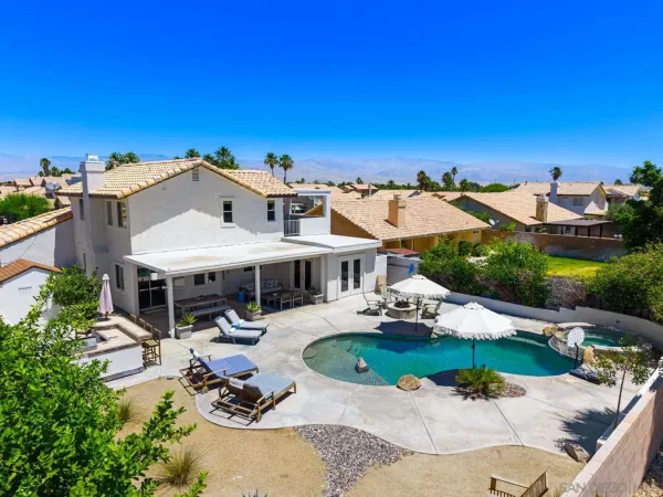 an aerial view of a house with a garden and swimming pool