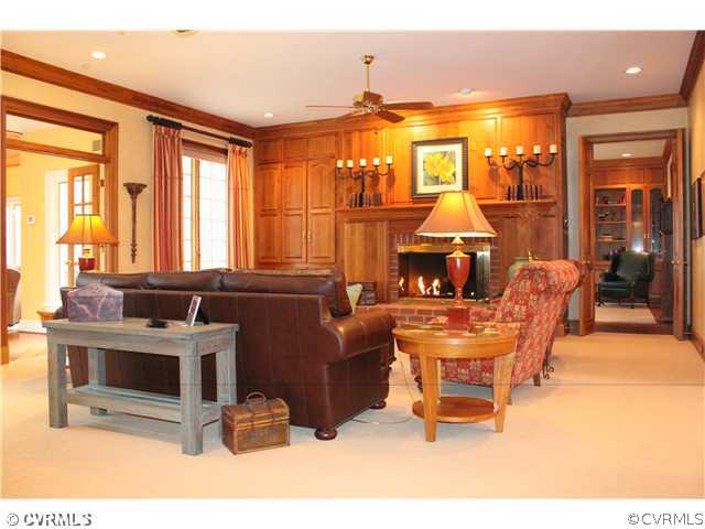 3811 Old Gun Road West Midlothian, VA 23113 - Photo 7 of 12 a living room with furniture a large window and a fireplace
