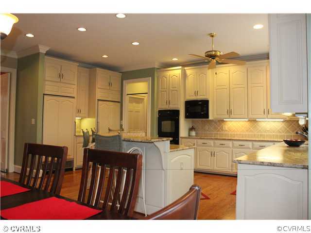 3811 Old Gun Road West Midlothian, VA 23113 - Photo 10 of 12 a kitchen with stainless steel appliances kitchen island granite countertop a sink and cabinets