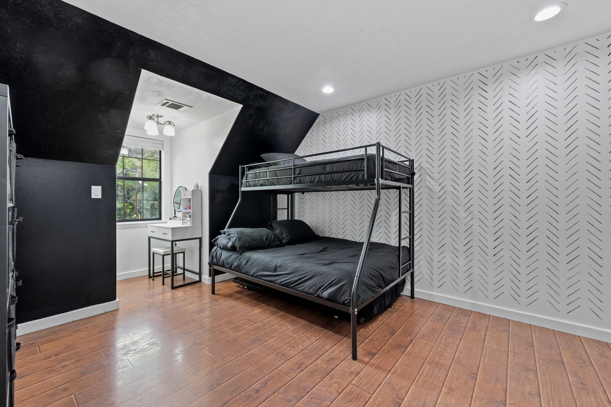 18 East Old Field Road Huffman, TX 77336 - Photo 24 of 35 Another generously sized secondary bedroom offering warm wood flooring, dramatic ceiling lines, custom wall designs, & flexible space ideal for guests, family, or additional living needs.