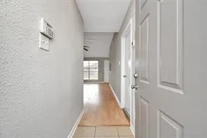 a view of a hallway with front door