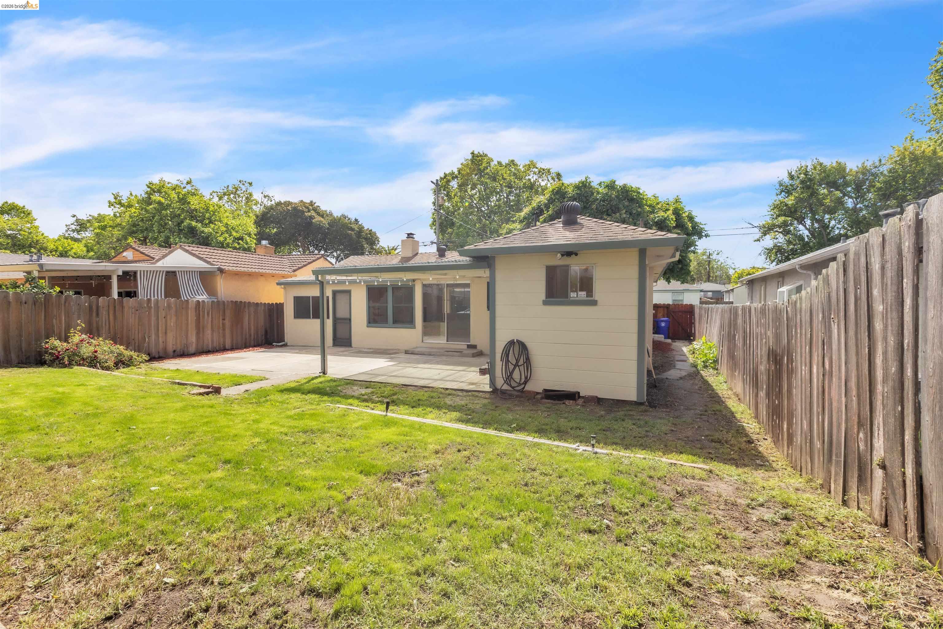 621 Paseo Del Rio San Lorenzo, CA 94580 - Photo 24 of 24 Rear exterior featuring a spacious lawn, concrete patio, and a covered patio area