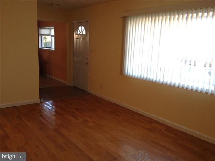 28 Comstock Road Edison, NJ 08817 - Photo 11 of 18 an empty room with wooden floor and windows