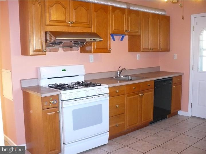 28 Comstock Road Edison, NJ 08817 - Photo 2 of 18 a kitchen with stainless steel appliances granite countertop a sink stove and cabinets
