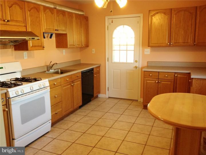 28 Comstock Road Edison, NJ 08817 - Photo 3 of 18 a kitchen with a sink a stove and cabinets