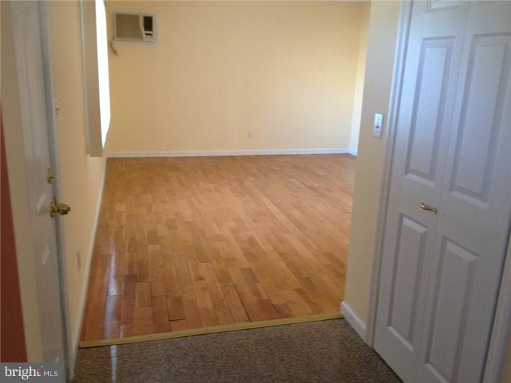 28 Comstock Road Edison, NJ 08817 - Photo 9 of 18 an empty room with wooden floor