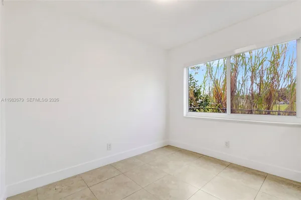 a view of an empty room with a window
