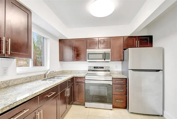 a kitchen with a refrigerator sink and stove